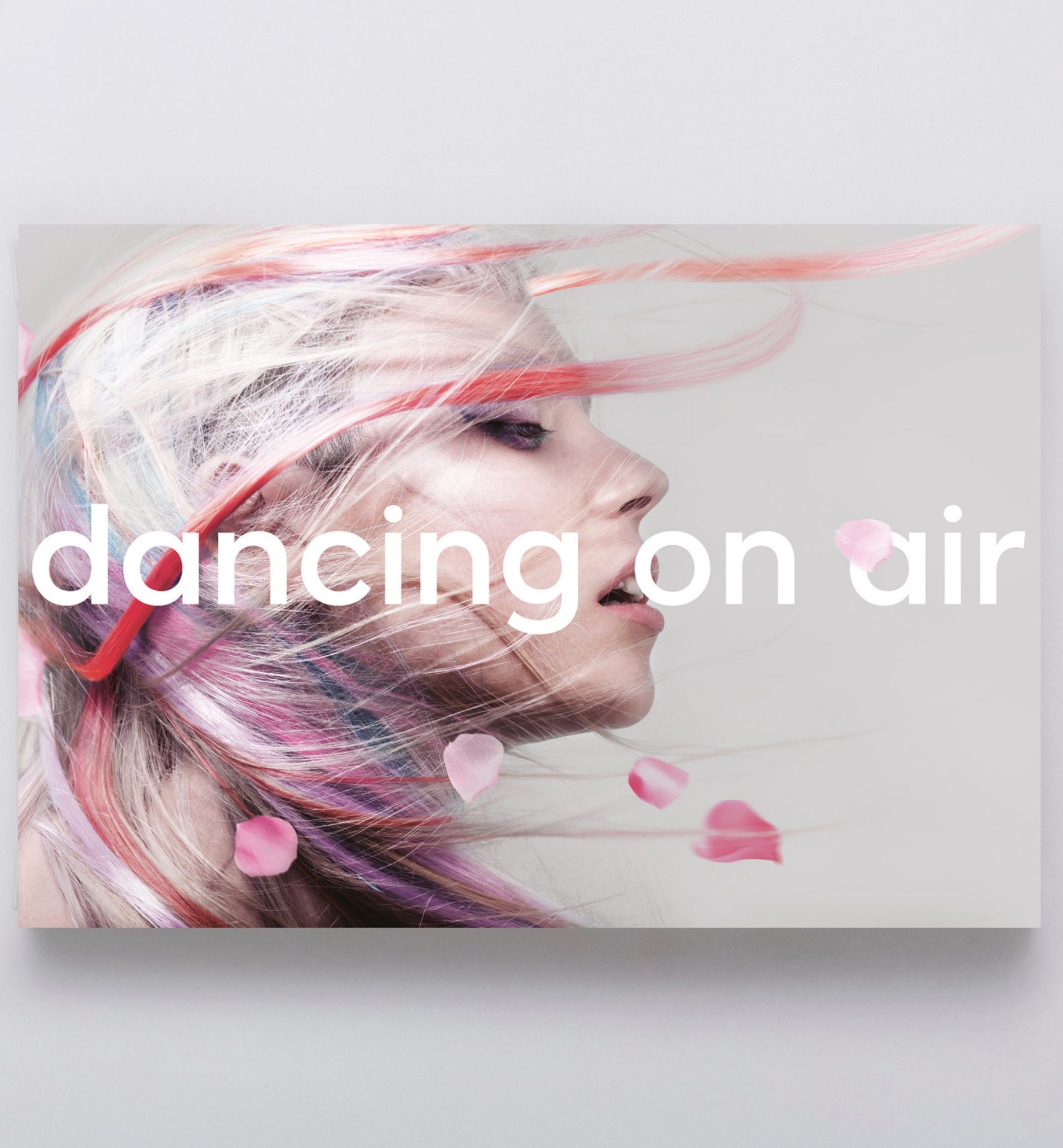 Abstract artistic portrait with flowing light streaks and text reading dancing on air
