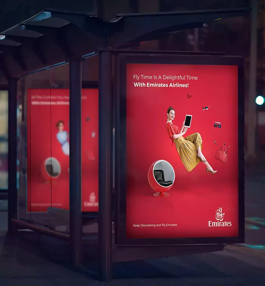 Red Emirates bus stop billboard advertisement displaying a woman seated with floating luxury items