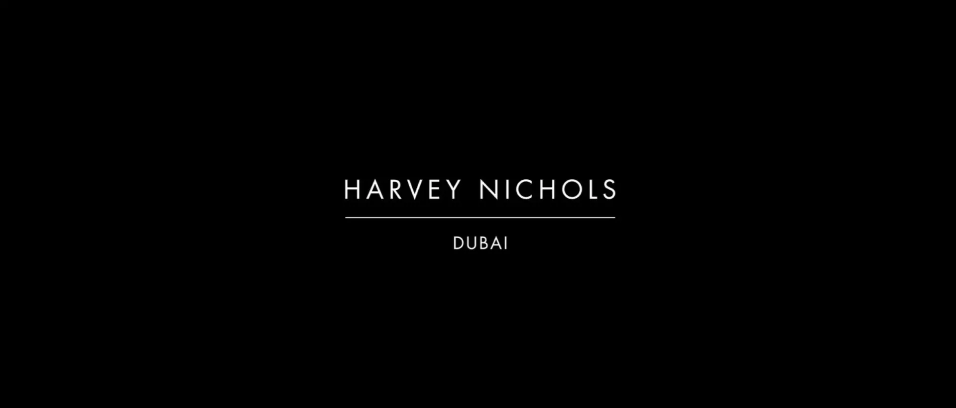 Minimalist black background featuring white typography for Harvey Nichols Dubai